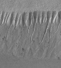 Evidence from Mars Global Surveyor (MGS) of relatively recent water flow down a valley side from underground aquifers.