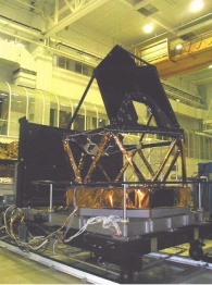 Telescope frame and test fixture mounted on the carriage which transports them into the test chamber. Image courtesy of and © 2004 Alcatel Space.