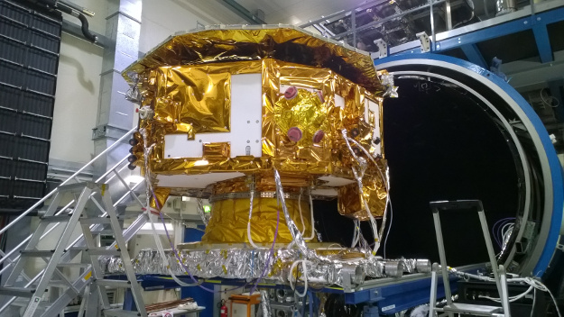 The LISA Pathfinder science module is pictured in front of the space environment vacuum test facility at IABG, Ottobrunn, Germany, in March 2015, prior to the start of thermal tests. These extra tests were carried out to check that the installation of cold gas thrusters, which had been done since the previous thermal test cycle, had not adversely affected the thermal behavior of the science module.